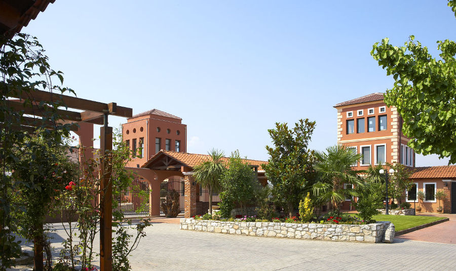 on side of 'Wine Art Estate' surrounded by stone pavement and plants and trees
